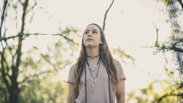 A woman walking through a forest