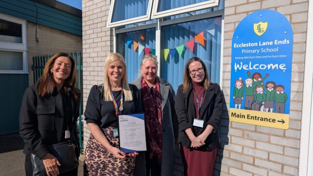 A teacher from Eccleston Lane Ends primary school stood with 3 people from Career Connect outside the school with a new careers accreditation certificate