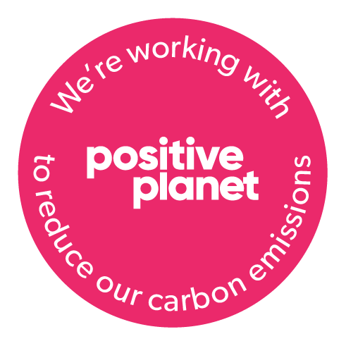 Positive planet logo in pink that says in white text we're working with Positive Planet to reduce our carbon emissions