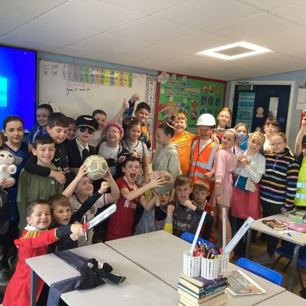 A large group of primary school children dressed as a variety of different professions in a classroom