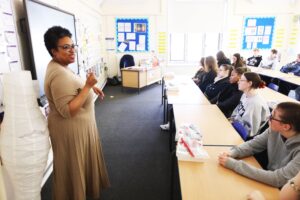 Careers adviser Judy at the front of a classroom talking to a class full of secondary school students