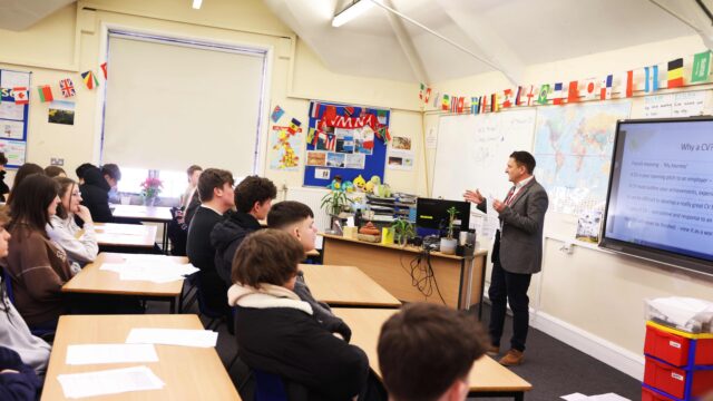 A careers adviser presenting a session on CVs to a class