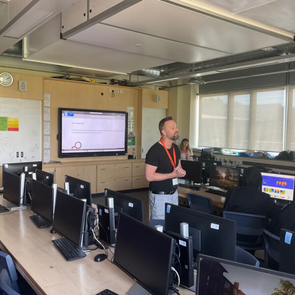 A careers adviser talking a group of students through how to use an online careers platform