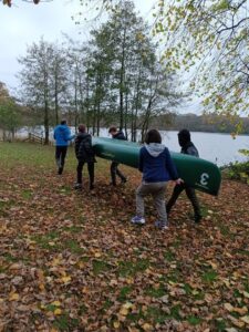 The young people had to work as a group to carry the two canoes down to the lake for one of the day's water-based activities.