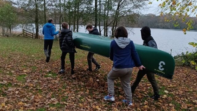 The young people had to work as a group to carry the two canoes down to the lake for one of the day's water-based activities.