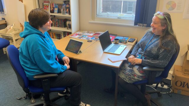 A young person in a careers interview with a Career Connect adviser. They are laughing.
