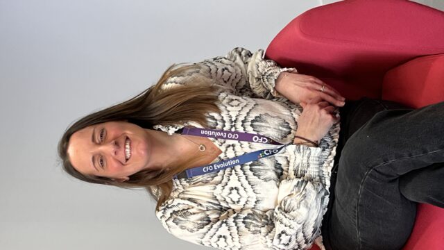 Natalie is a support worker on the CFO Evolution contract. She is sitting in a chair smiling and looking friendly.