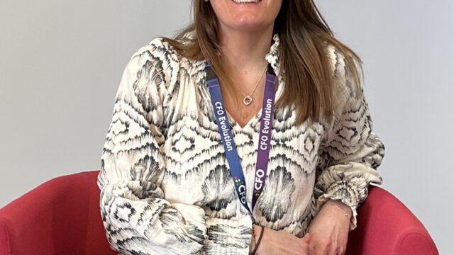 Natalie is a support worker on the CFOE contract. She is sitting in a chair smiling and looking friendly.