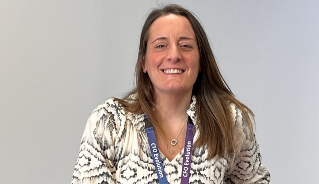 Natalie is a support worker on the CFOE contract. She is sitting in a chair smiling and looking friendly.