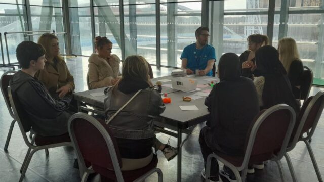 A group of young people taking part in a round-table discussion about the challenges they face and the way the Discover Your Future programme can help them.