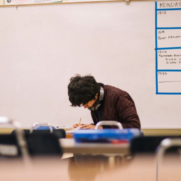A student sat in an empty classroom engrossed in his studies
