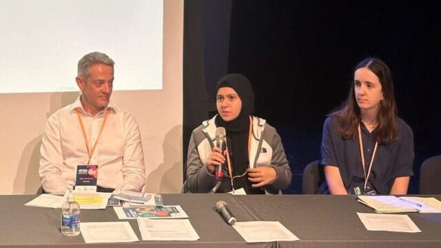 Youth Ambassador Yasmina speaking on a panel at a conference on youth employment.