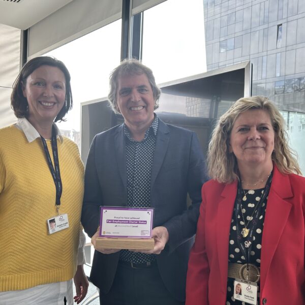 Career Connect CEO Sheila Clark (right) and Director of HR Danielle Kneale (left) receive the Liverpool City Region Fair Employment Charter Accredited Status Award from Metro Mayor Steve Rotherham (centre).