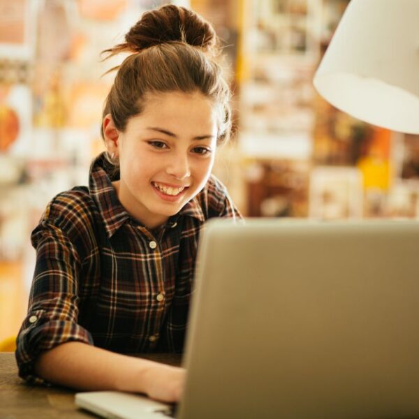 Image of a young girl looking at a computer