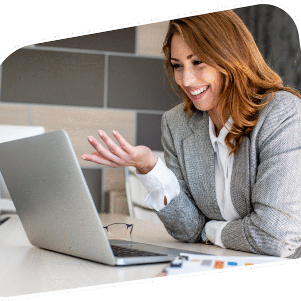 A smartly dressed woman having a video call using a laptop