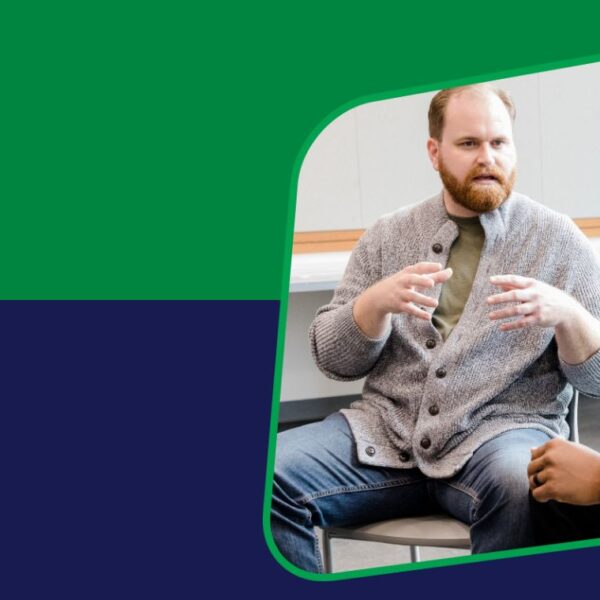 Banner featuring two men having a discussion in a workplace setting