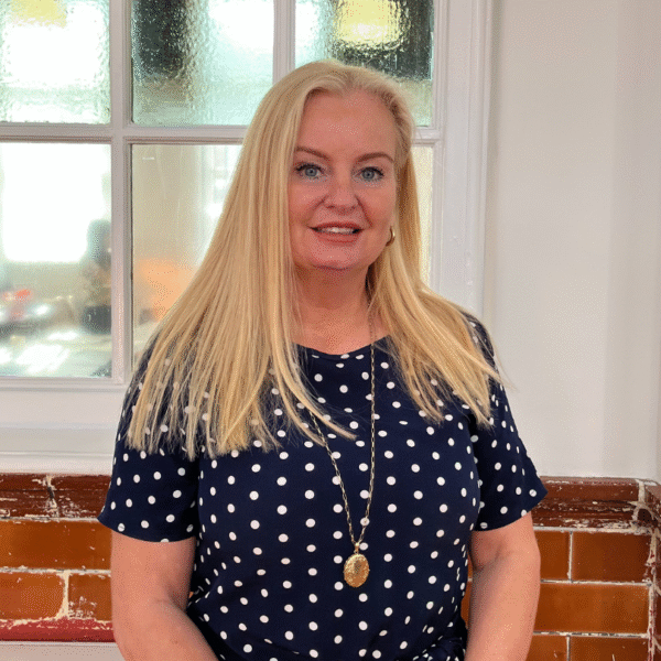 Helen Cottom standing and smiling at the camera