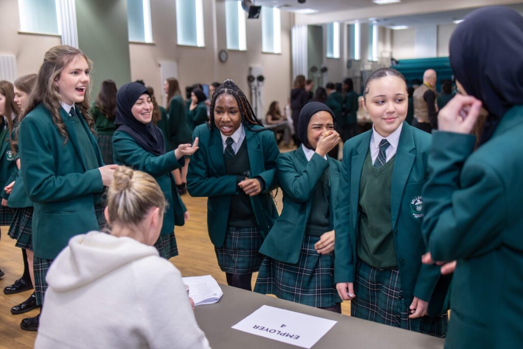 A group of year 9 schoolgirls interview a mystery employer, trying to work out what her job is.