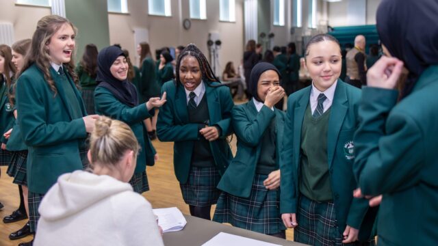 A group of year 9 schoolgirls interview a mystery employer, trying to work out what her job is.