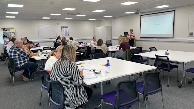 A group of people sat at tables at Lincolnshire Career Hub