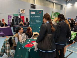 A group of female students visiting a stand at the What Next Skills Show.