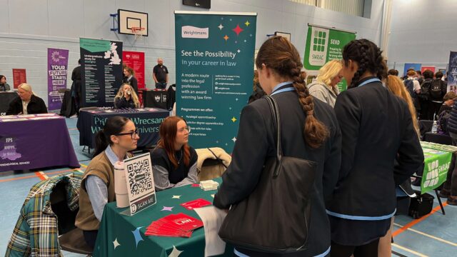 A group of female students visiting a stand at the What Next Skills Show.