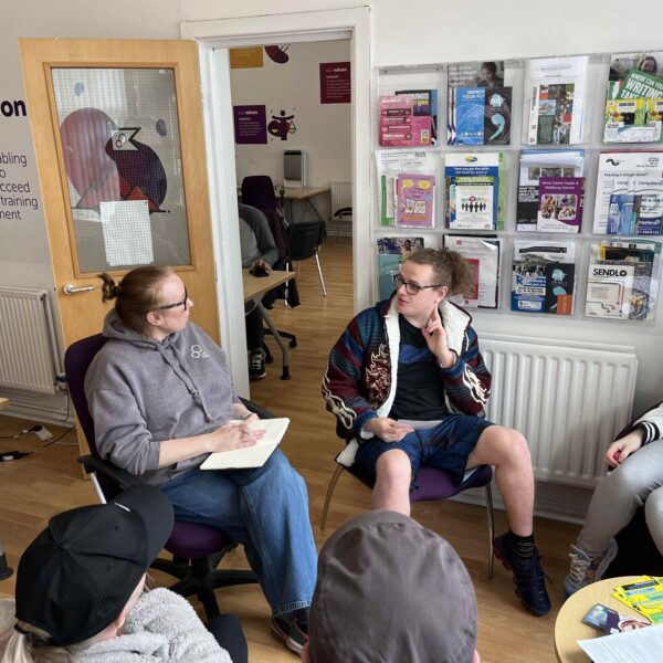 A young man speaking to a careers adviser at Career Connect.