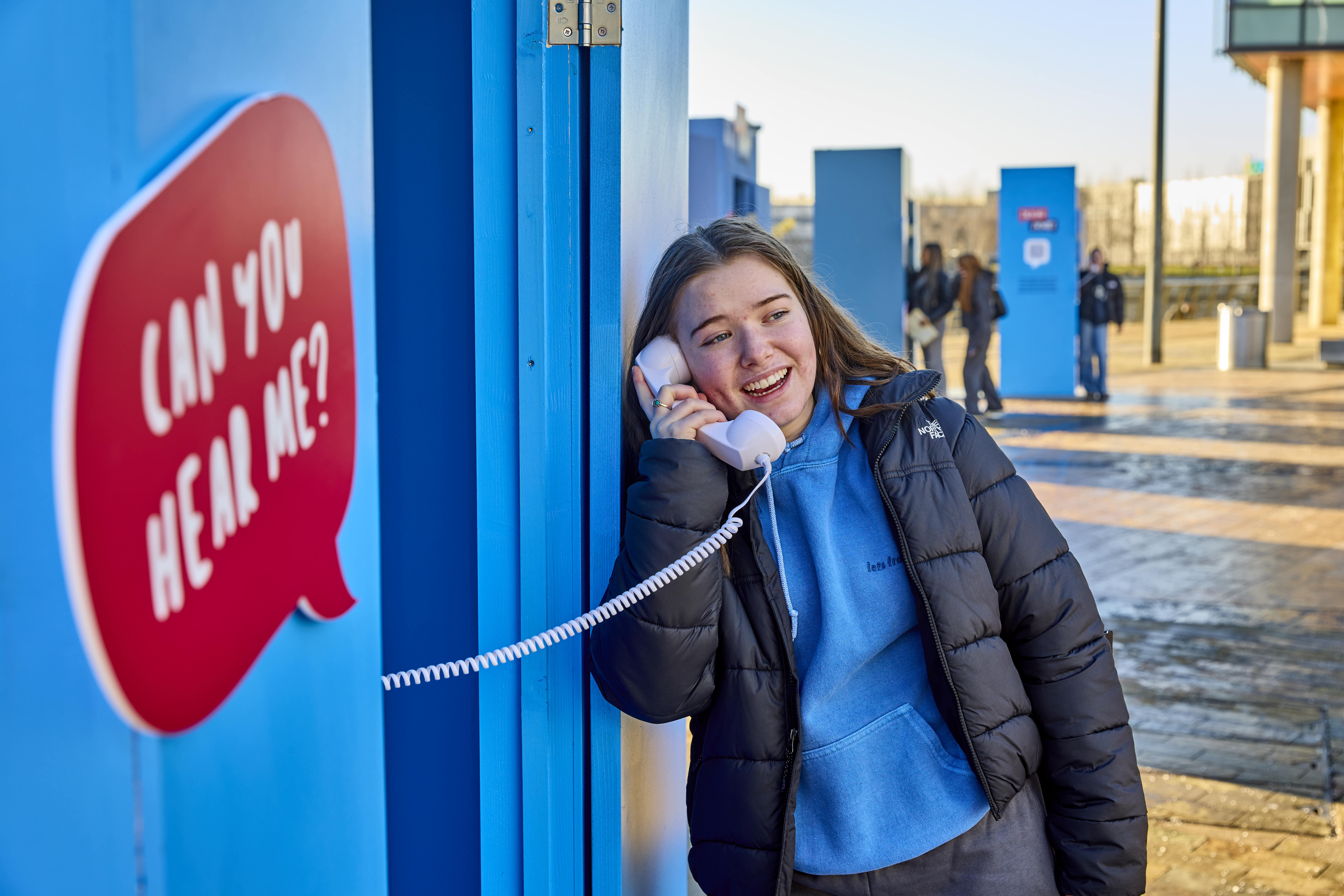 A woman talking to a careers adviser on a photo using one of the booths from the Talking Futures installation.